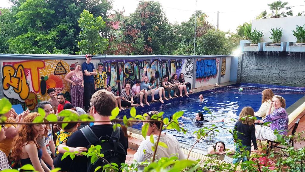 a group of people sitting in a swimming pool at Siem Reap Pub Hostel in Siem Reap