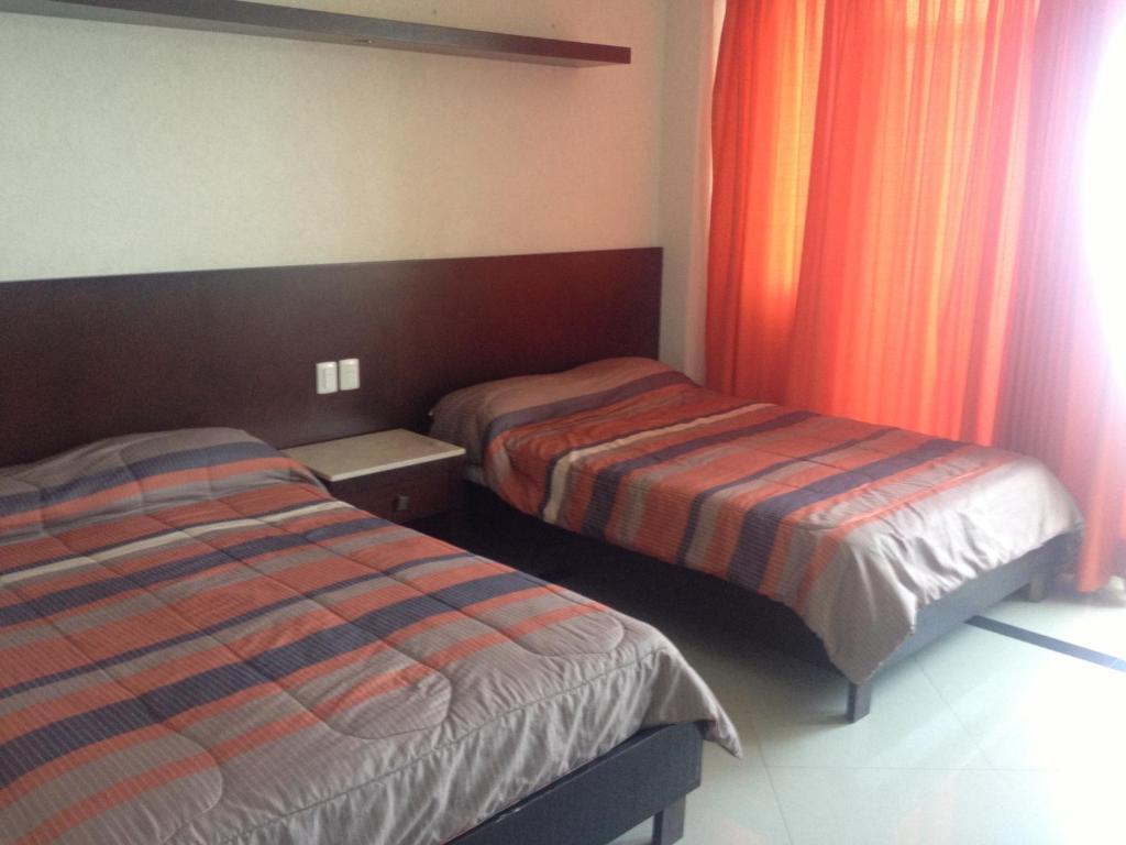 Postel nebo postele na pokoji v ubytování Hotel Bogavante