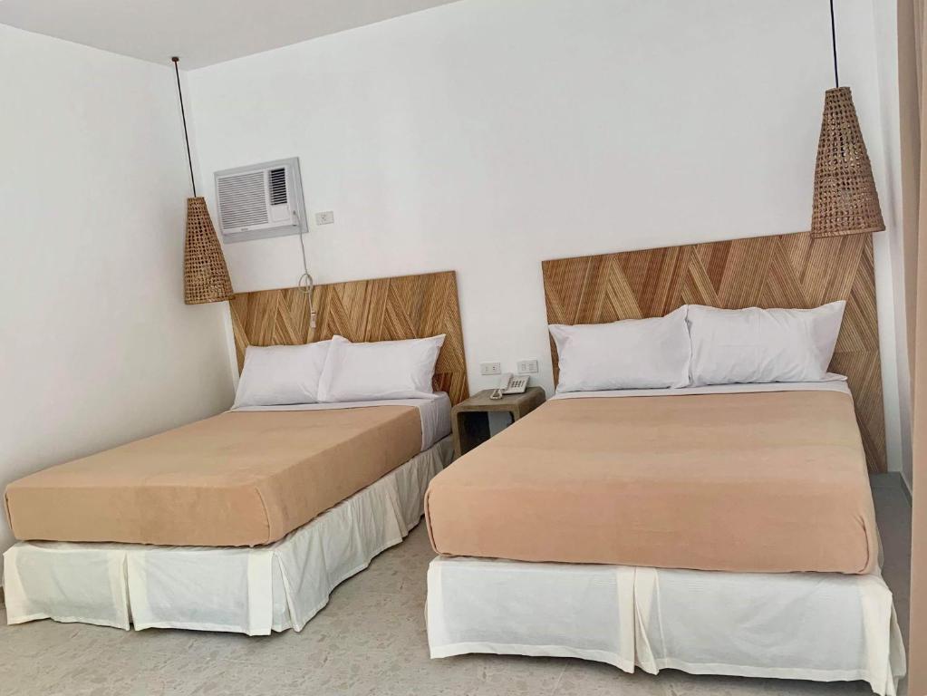 Postel nebo postele na pokoji v ubytování Cebu R Resort Tabuelan