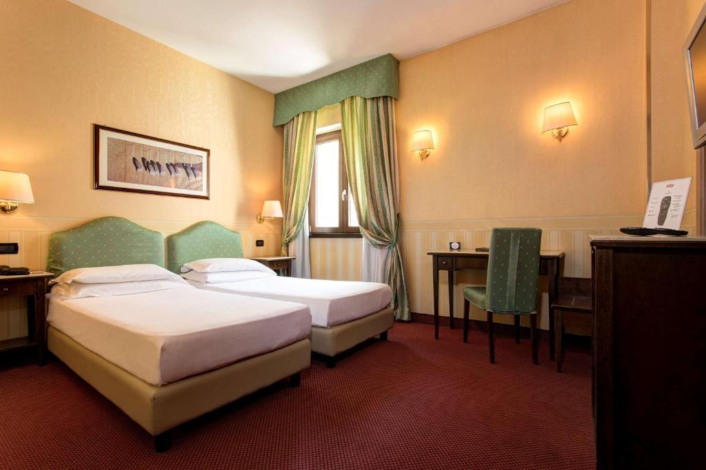 Postel nebo postele na pokoji v ubytování Best Western Hotel Tritone