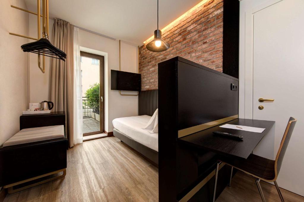 Postel nebo postele na pokoji v ubytování Best Western Hotel Tritone
