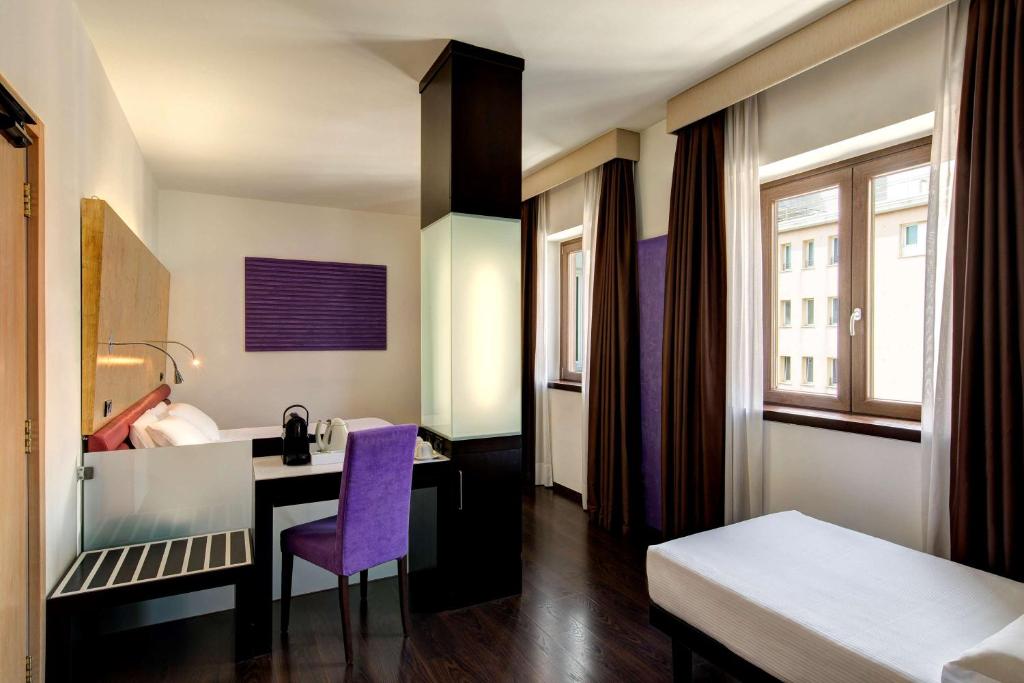 Postel nebo postele na pokoji v ubytování Best Western Hotel Tritone