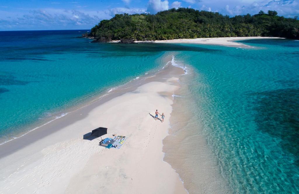 an aerial view of a beach with two people on it at Yasawa Island Resort & Spa in Mbukama