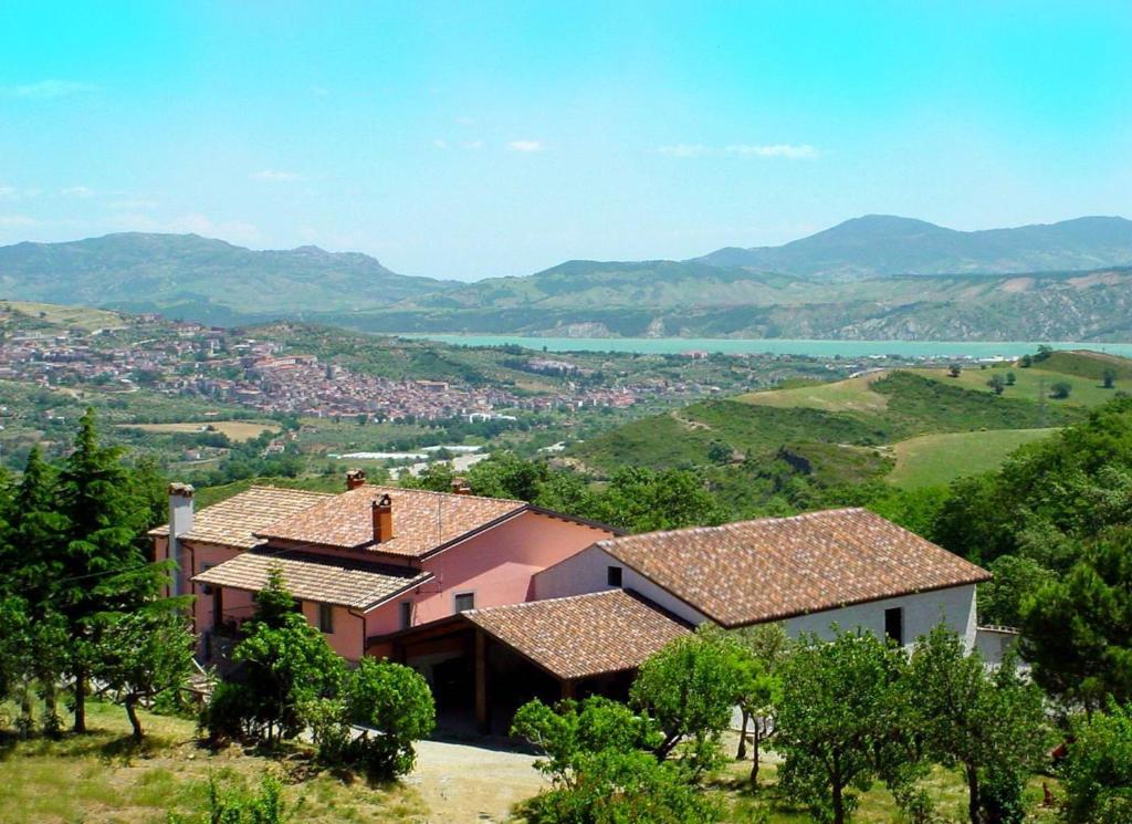 a group of houses on a hill with a view at Arcomano Country House in Chiaromonte