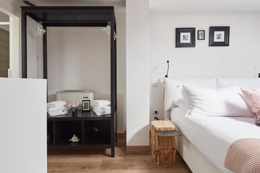a bedroom with a bed and a table with a mirror at Celeste's House in Florence
