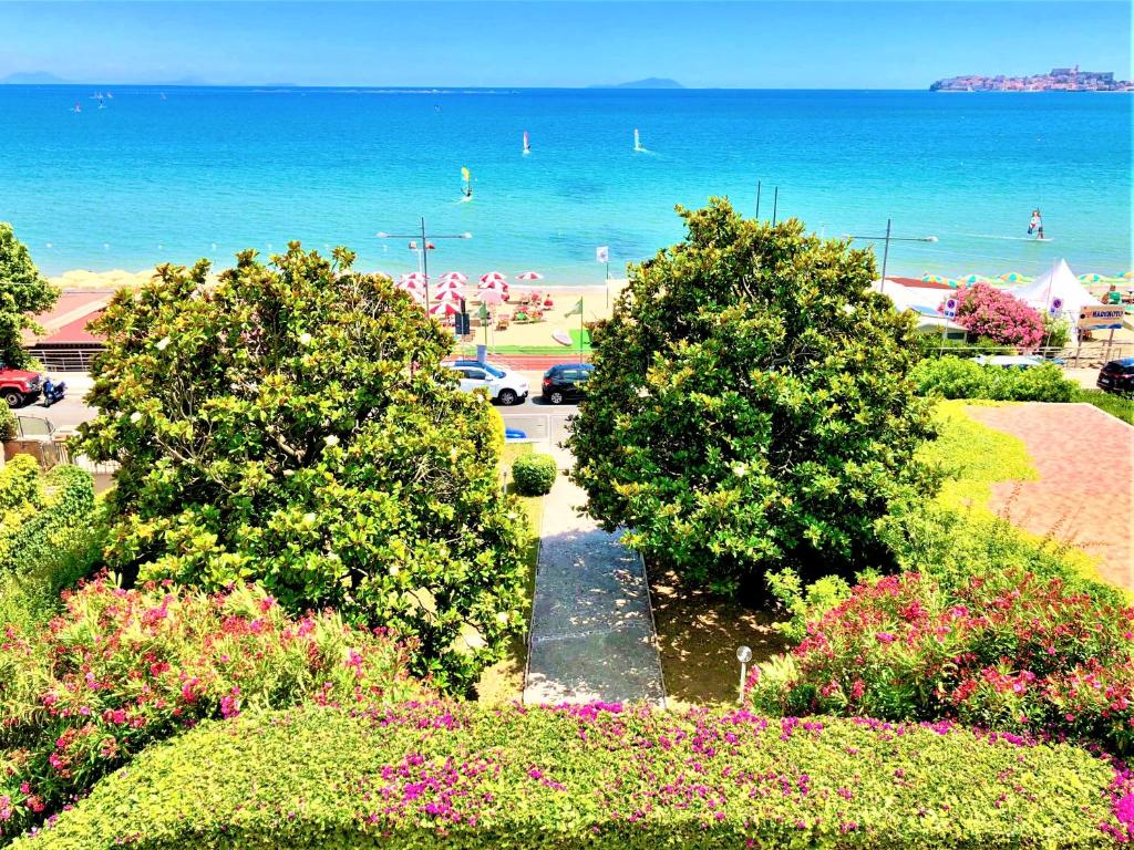 a view of a beach with trees and the ocean at Villa Magnolia in Formia