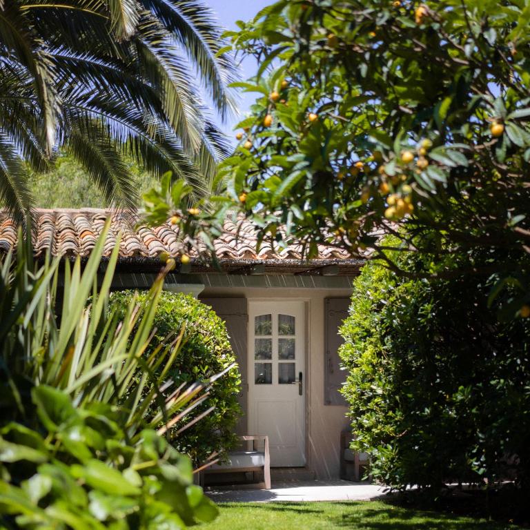 a house with a white door and some trees at Le Pre de la Mer in Saint-Tropez