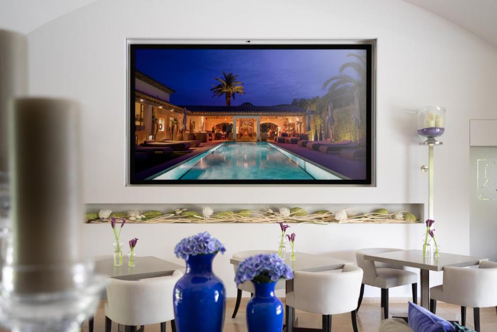 a painting of a villa with a swimming pool at Le Pre de la Mer in Saint-Tropez