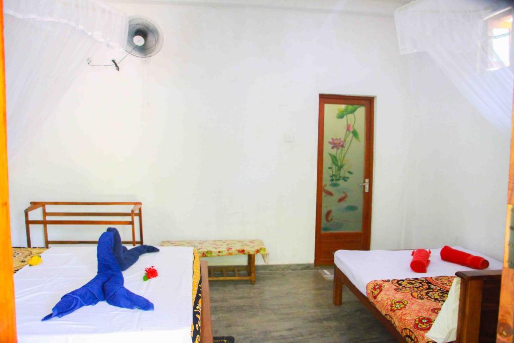 Postel nebo postele na pokoji v ubytování Amba Sewana Homestay