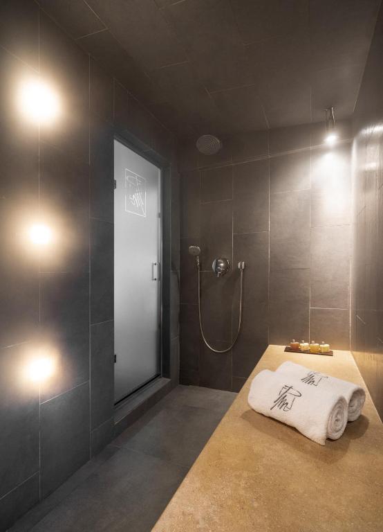 a bathroom with a shower and a white towel at Le Pre de la Mer in Saint-Tropez