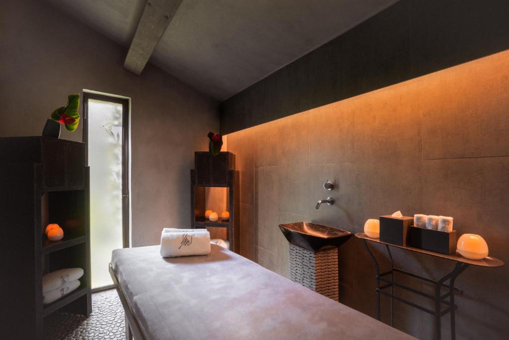 a bedroom with a bed and a sink in a room at Le Pre de la Mer in Saint-Tropez