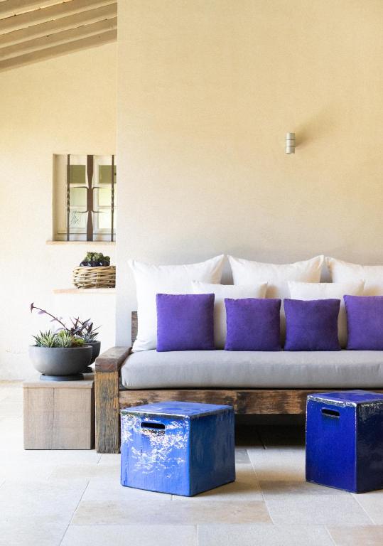 a living room with a couch with purple pillows at Le Pre de la Mer in Saint-Tropez