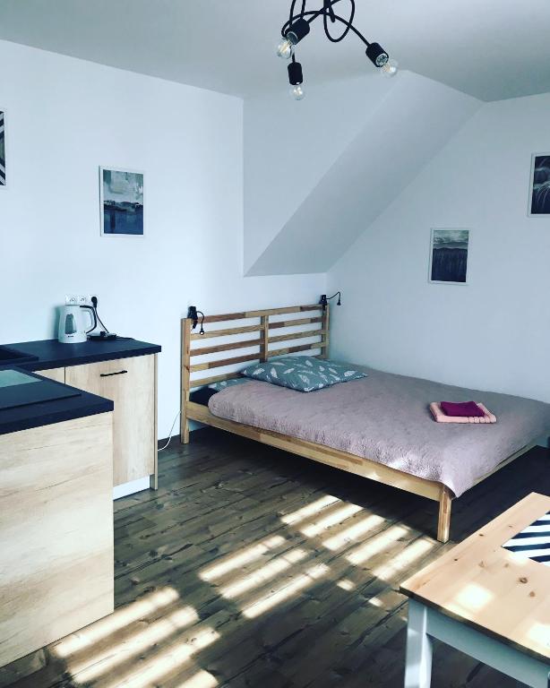 a bedroom with a bed in the corner of a room at Bielski Zakątek bezobsługowy in Bielsko-Biała