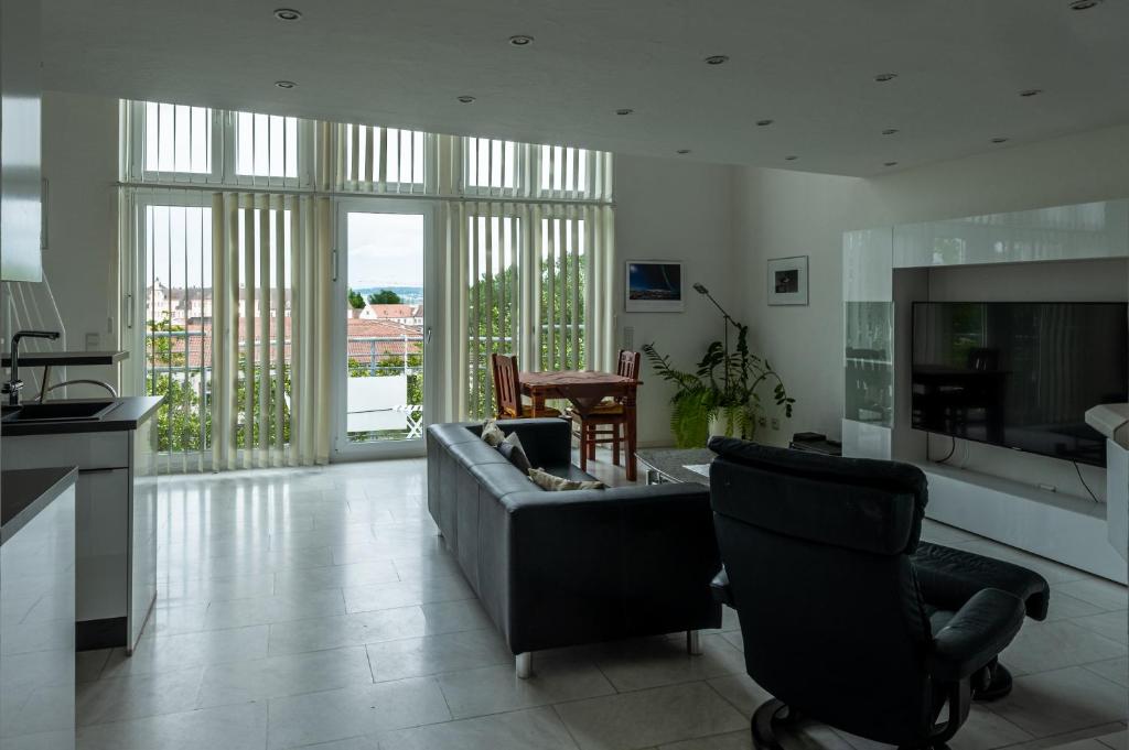 a living room with a couch and a chair at Ferienwohnung Seerhein in Konstanz