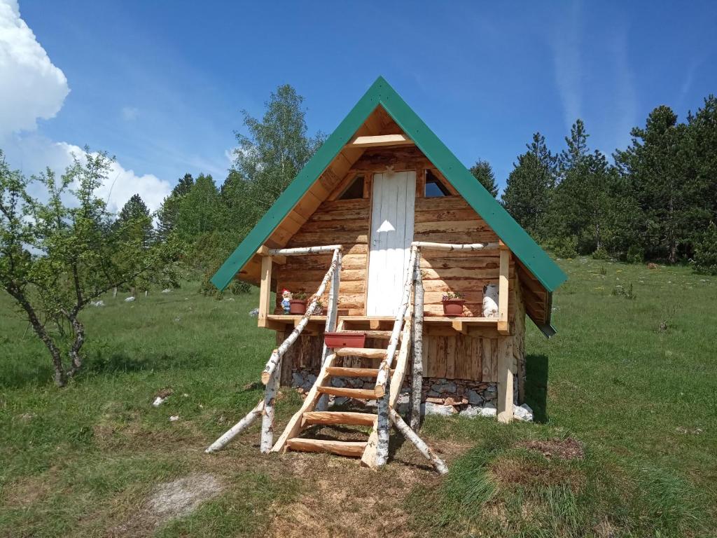 Cabaña de madera pequeña con techo verde en Bungalovi Mijakovici en Pljevlja