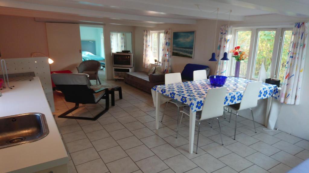 a kitchen and living room with a table and chairs at B&B Hesselbjerg in Hesselbjerg