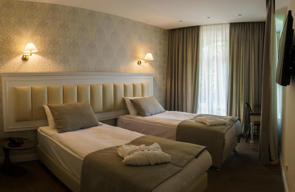 Postel nebo postele na pokoji v ubytování Hotel Passport Tbilisi
