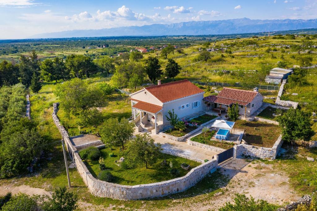 an aerial view of a house in a field at Holiday home Ante with beautiful private garden in Nadin