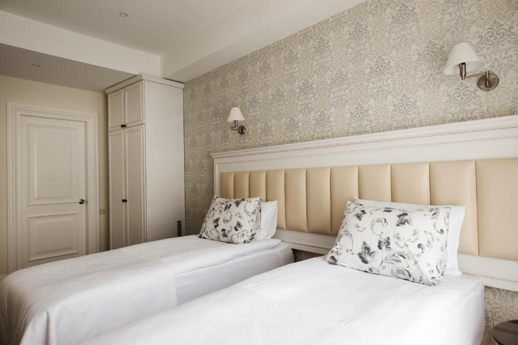 Postel nebo postele na pokoji v ubytování Hotel Passport Tbilisi