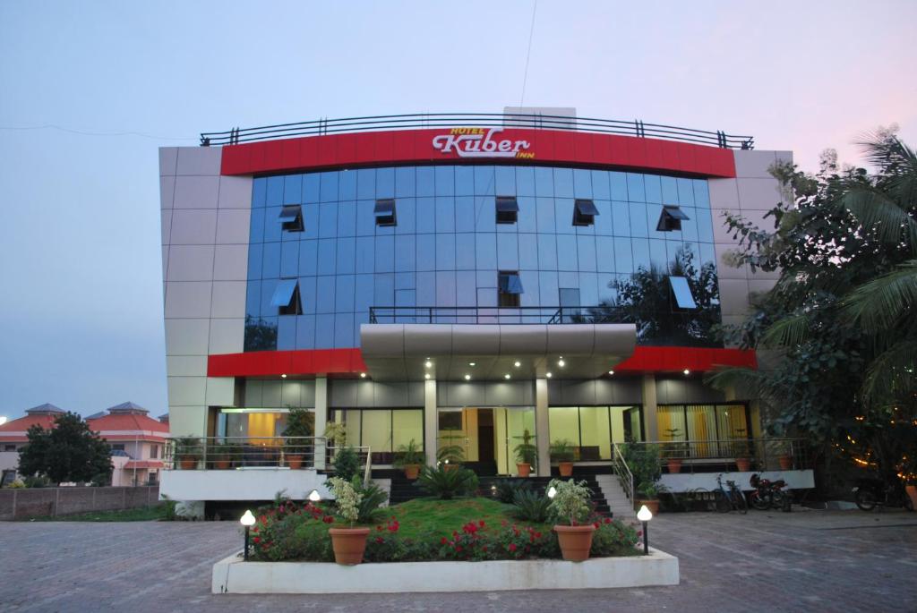 a building with a sign on the side of it at Kuber Inn in Shirdi