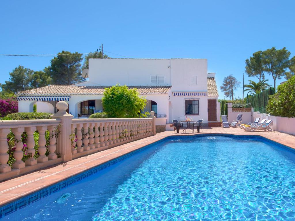 a villa with a swimming pool in front of a house at Holiday Home Cala Vista by Interhome in Balcon del Mar
