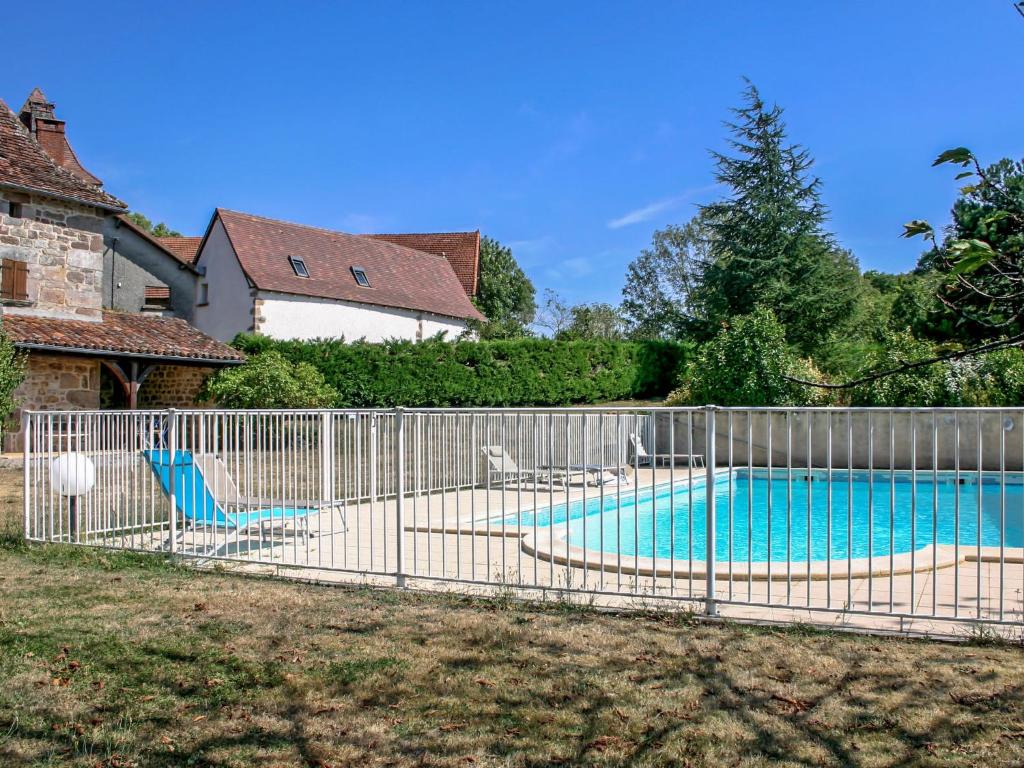 a fence around a swimming pool in a yard at Holiday Home La Grange by Interhome in La Valade