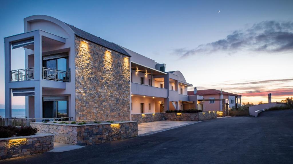 a building with lights on the side of it at Royalty Suites Loft in Nikiti