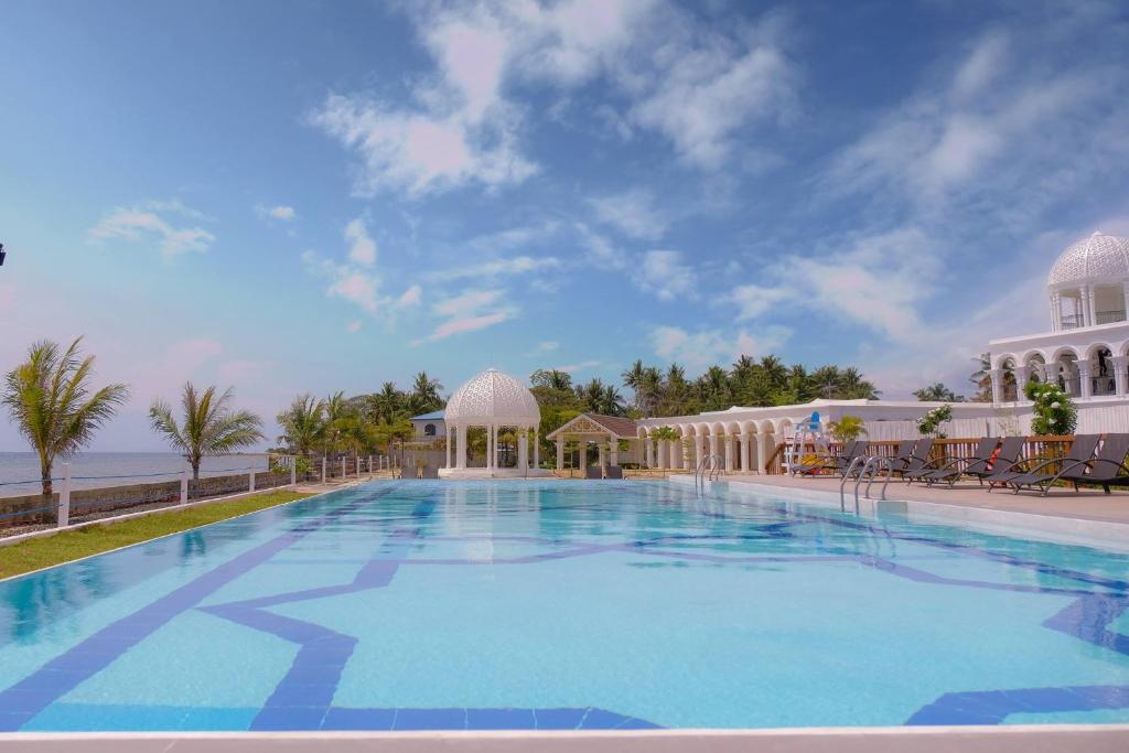 a large swimming pool in front of a building at Maayo Argao in Argao