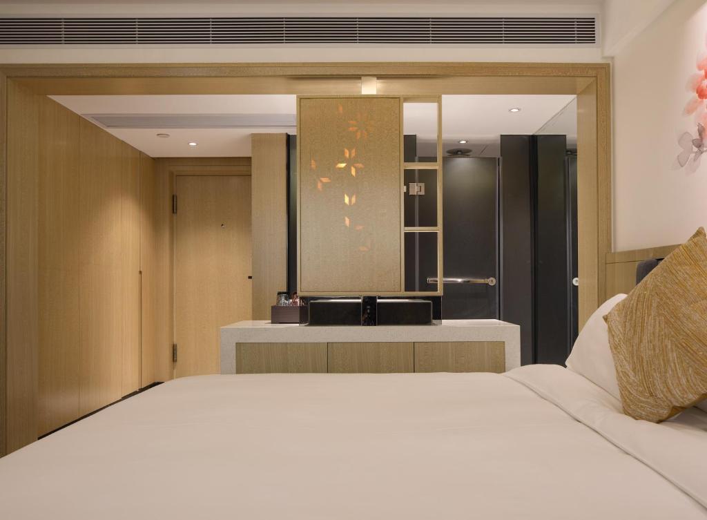 Postel nebo postele na pokoji v ubytování Paco Hotel Guangzhou Jiangtai Road Metro Branch