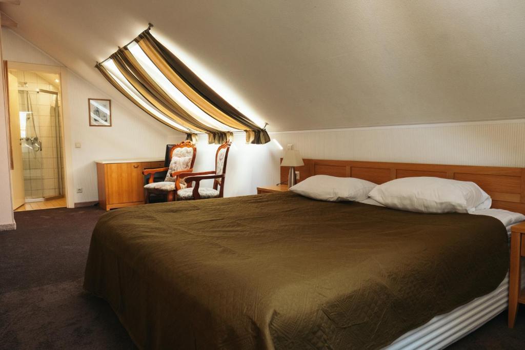 Un pat sau paturi într-o cameră la Hotel Vila Diemedis