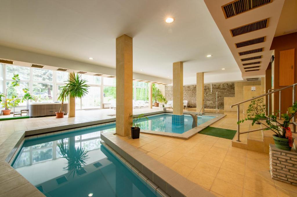 an indoor pool in a home with a house at Hotel Fit Hévíz in Hévíz