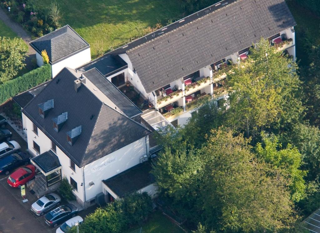 an overhead view of a house with a parking lot at Kurparkhotel-Gemünd in Gemünd