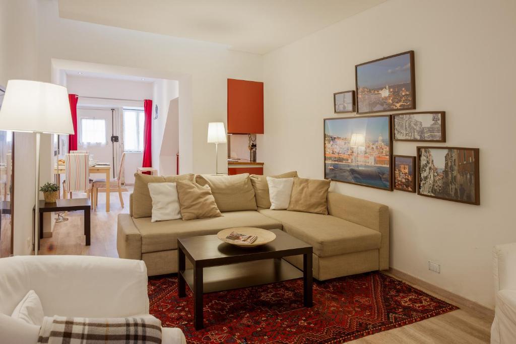 a living room with a couch and a table at Charming flat in Lisbon's center! in Lisbon