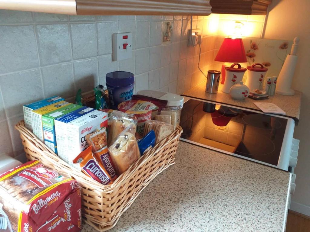 a kitchen with two baskets of food on a counter at Nick & Sandra's in Slane