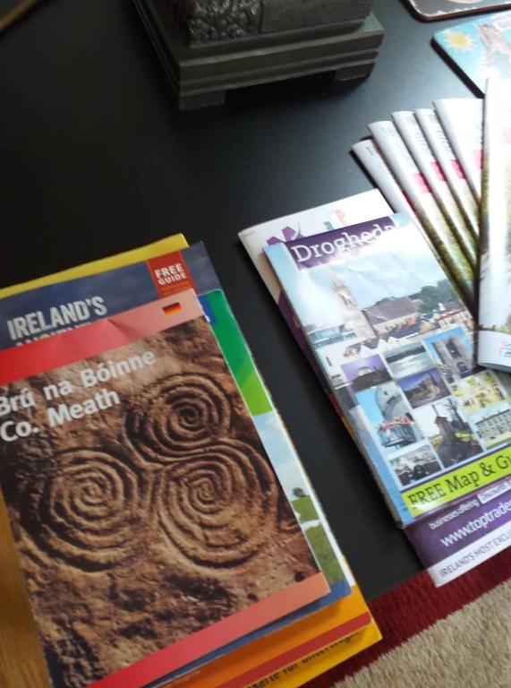 three magazines sitting on a table next to each other at Nick & Sandra's in Slane