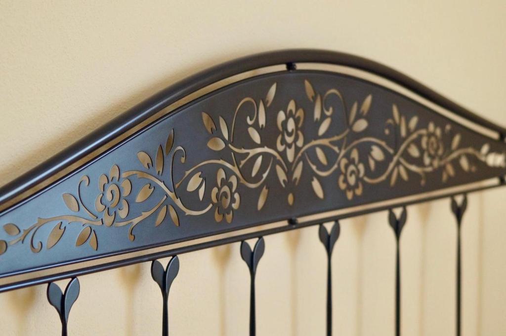 a black metal railing with gold flowers on it at L'Antico Borgo B&B in Levanto