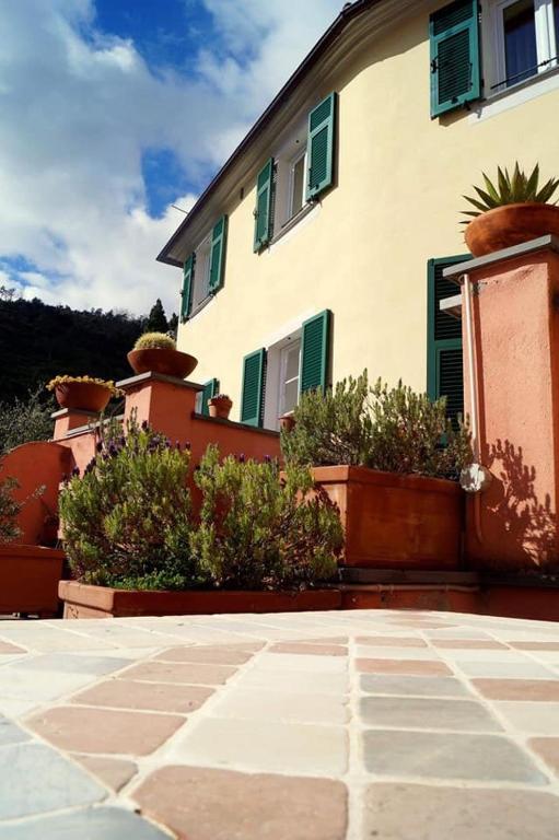 a building with potted plants in front of it at L'Antico Borgo B&B in Levanto