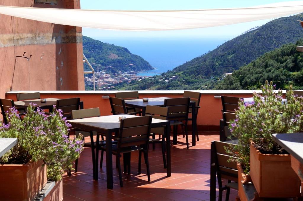 a restaurant with tables and chairs on a balcony at L'Antico Borgo B&B in Levanto