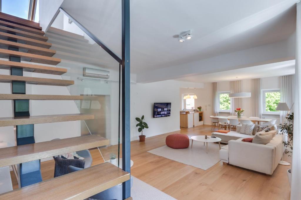 a living room with a staircase in a house at Fine Ljubljana Apartments in Ljubljana