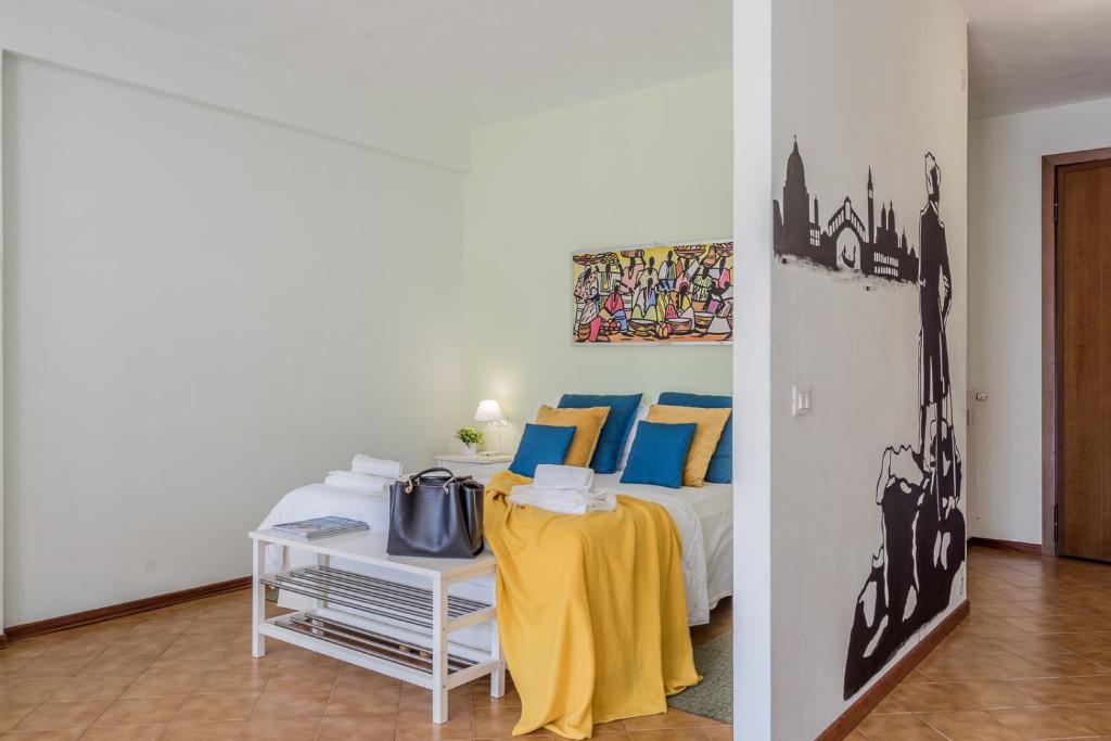 Łóżko lub łóżka w pokoju w obiekcie ARCA Conte Rosso Apartments