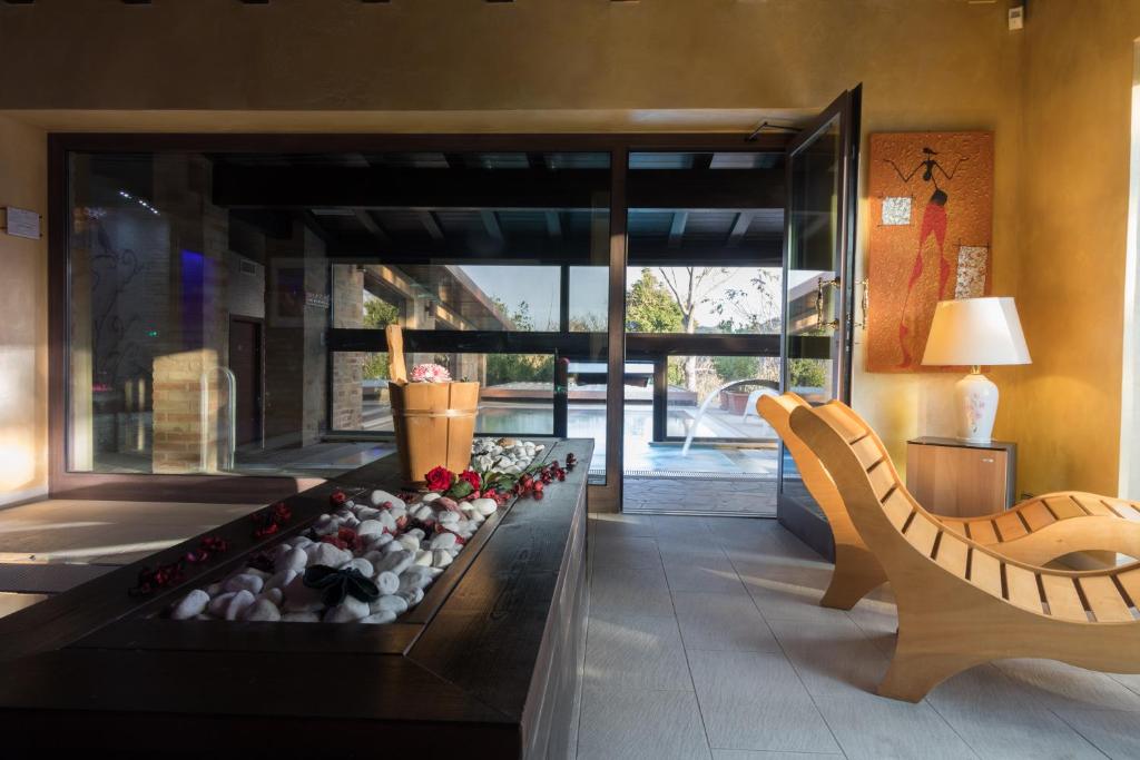 a living room with a fireplace and a couch at Colle Indaco Wine Resort & Spa in Ortezzano