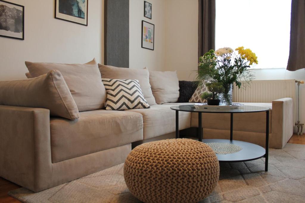 a living room with a couch and a table at Very central cozy apartment in Novi Sad