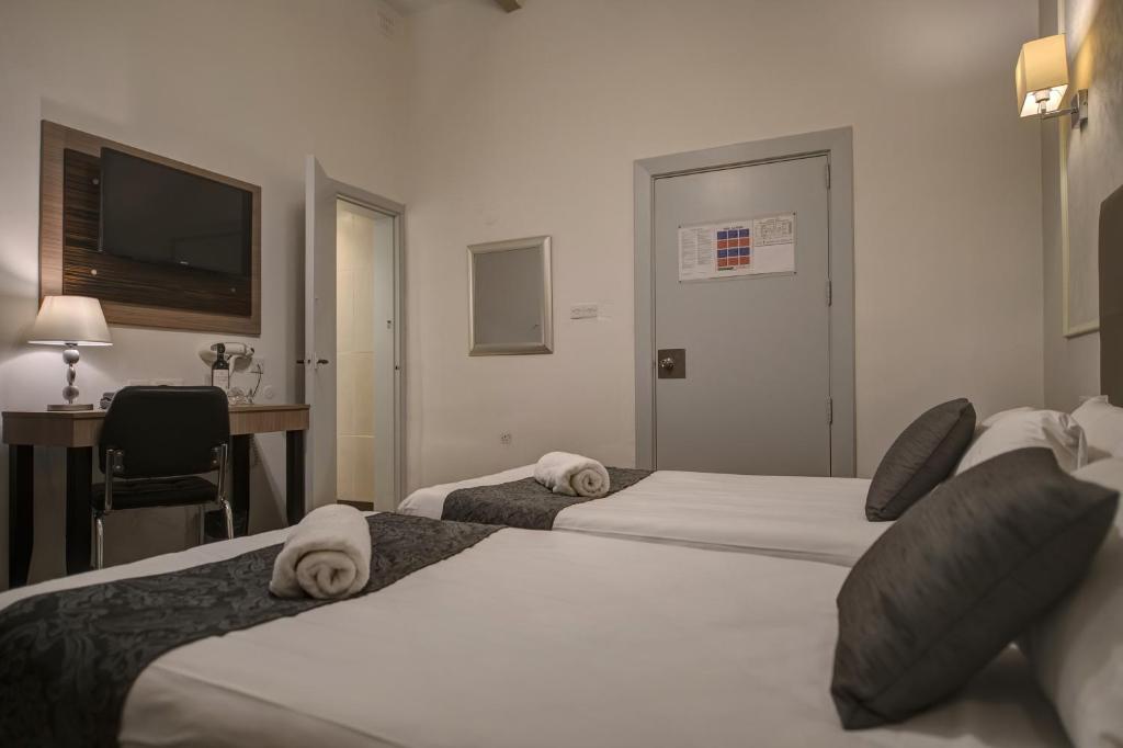 Postel nebo postele na pokoji v ubytování Europa Hotel