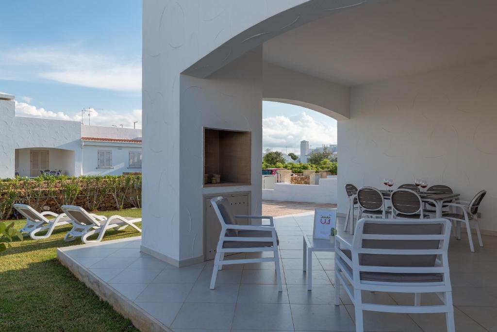 a patio with chairs and a table on a patio at Blue Sea Villas by Wonderful Italy in Ostuni