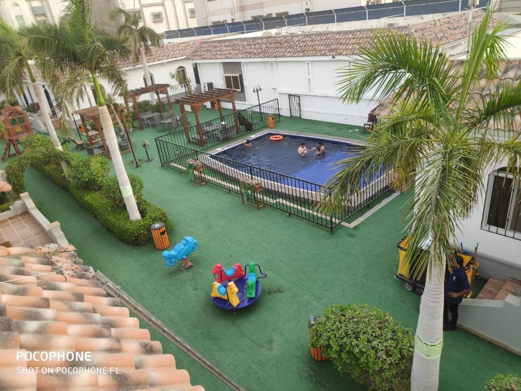 an overhead view of a swimming pool with people in it at Jeddah Wakan Villas in Jeddah