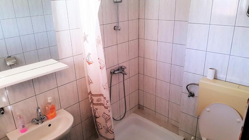 a bathroom with a shower with a toilet and a sink at Apartments Niko Metajna, island Pag in Metajna