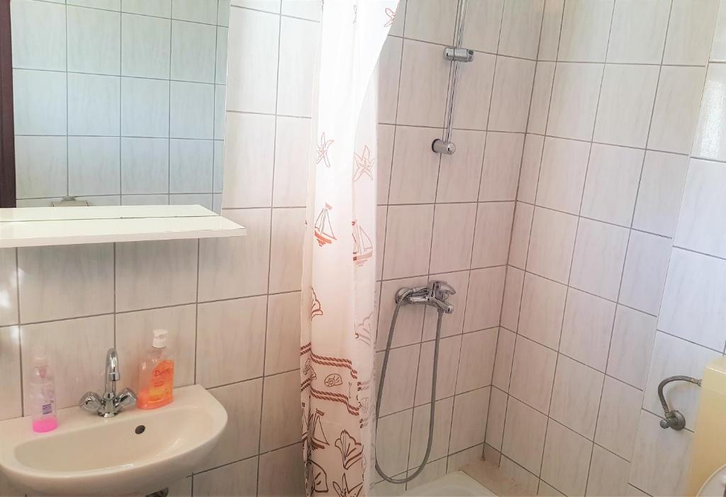 a bathroom with a shower and a sink at Apartments Niko Metajna, island Pag in Metajna