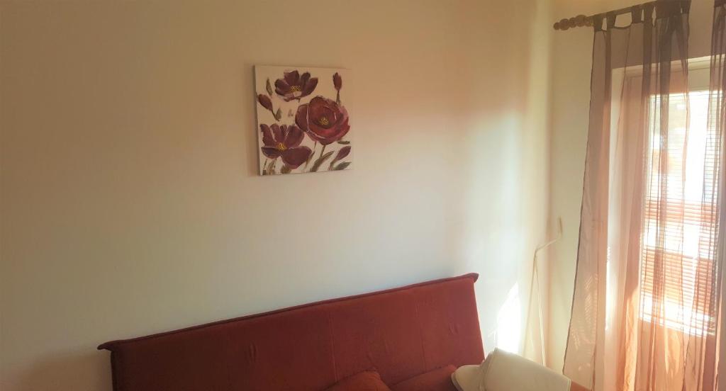 a living room with a couch and a picture on the wall at Apartments Niko Metajna, island Pag in Metajna