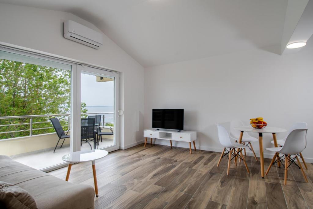 a living room with a couch and a table at Apartments Mijo in Dugi Rat