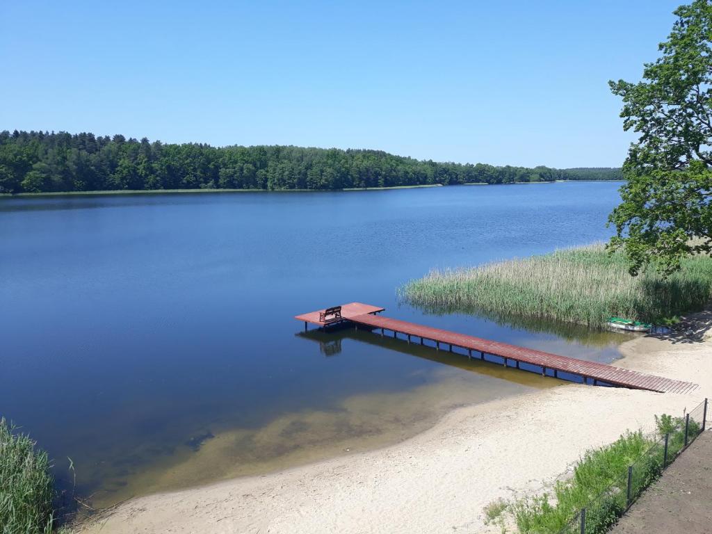 a dock in the middle of a lake at Mazurskie Klimaty Tatarak in Olsztyn